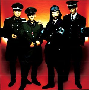 Following the release of the album WAT (Mute Records,2003), <!--LINK'" 0:310--> carried out a major European tour in 2003. Sung in both German and English WAT pondered the major topics of the Iraq War, anti-Semitism, terrorism and crisis in the modern world.