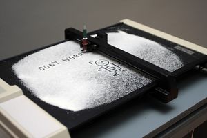 <i>Nanoplotter</i> uses a plotter, an obsolete printing machine from the 1980s, adapted to an uncommon operation. By the artist collective <!--LINK'" 0:33--> at the <i><!--LINK'" 0:34--></i>, <!--LINK'" 0:35-->, Ljubljana, 2010.