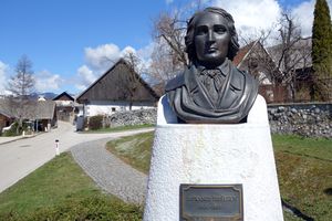 France Prešeren bust in Vrba, the <!--LINK'" 0:266--> the background. A bronze replica of a plaster statue created in 1865 by <!--LINK'" 0:267-->, 2013