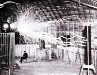 Publicity photo of Nikola Tesla sitting in his laboratory in Colorado Springs in December 1899. Photo was taken by Dickenson V. Alley, photographer at Century Magazines. Wikimedia commons, public domain.