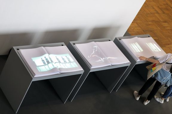 A part of the Warped Space installation representing Slovenia at the Prague Quadrennial of Performance Design and Space 2019: a book triptych with projected images of selected set and costume designs by Angelina Atlagić, Uroš Belantič, Mateja Bučar & Vadim Fiškin, Leo Kulaš and NUMEN. Curated by Barbara Novakovič and produced by Muzeum Institute.