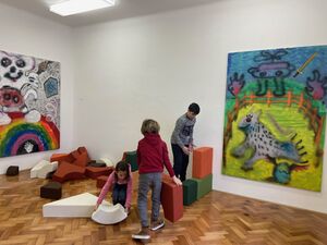 Exhibition space and the game <i>Let's Build the World Anew in Every Hue</i> at <!--LINK'" 0:53-->.