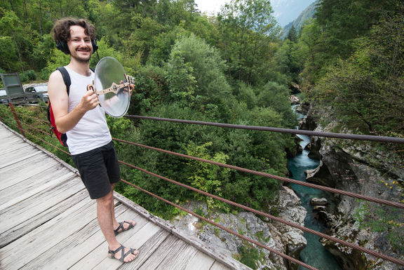Klemens Kohlweis with his parabolic directed microphone above Soča river, PIFcamp, 2018.