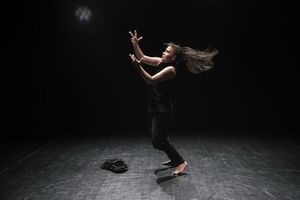 <!--LINK'" 0:112--> on the small stage of the <!--LINK'" 0:113--> during her piece <i>Zaklenjeno</i> [Locked], performed at the <!--LINK'" 0:114-->, 2017