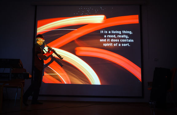 Lado Jakša during his multimedia act, merging photography, poetry and solo saxophone at Festival of Slovenian Jazz, 2014