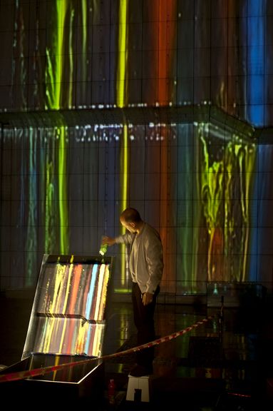 Gravitational painting on the facade of Cankarjev dom, Cultural and Congress Centre by Portugese/Belgian duet Ocubo, Lighting Guerrilla Festival, 2012