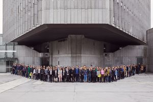 A group portrait of Biennial of Design 2019 participants, standing in front of the <!--LINK'" 0:67--> in Ljubljana