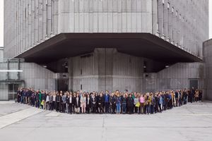 A group portrait of Biennial of Design 2019 participants, standing in front of the <!--LINK'" 0:234--> in Ljubljana