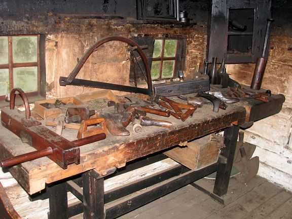 Inside Kavčnik Homestead a wood working bench with various handtools for carpentry and repairs sits ready for use