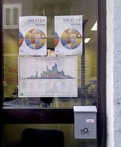 <!--LINK'" 0:63--> infographic calendar next to the <!--LINK'" 0:64--> posters on the festival's office window, 2012