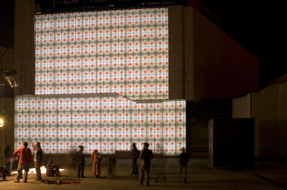 Human tiles by Ocubo projected on the facade of Cankarjev dom, Cultural and Congress Centre, Lighting Guerrilla Festival, 2010