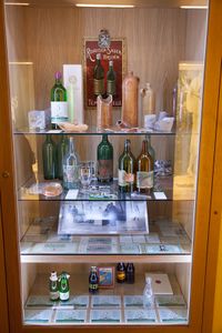 A display cabinet with healing mineral water bottles (the oldest ones made of clay) and old bottle labels. <!--LINK'" 0:182--> at Ana's Mansion, 2012