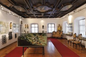 A model of the town of Kropa below an originally preserved cassette ceiling decorating the mansion that hosts the <!--LINK'" 0:1069-->.