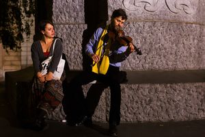 Street musicians playing under the statue of a romantic poet <!--LINK'" 0:642--> on Prešeren Square, the central square in <!--LINK'" 0:643-->, 2014