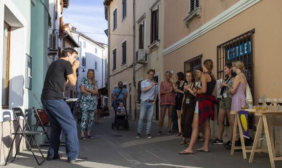 Artist Miha Erič performing in front of Salsaverde gallery at the opening of the festival exhibition of the Arts Academy of the University of Nova Gorica, Kino Otok - Isola Cinema Festival 2021.