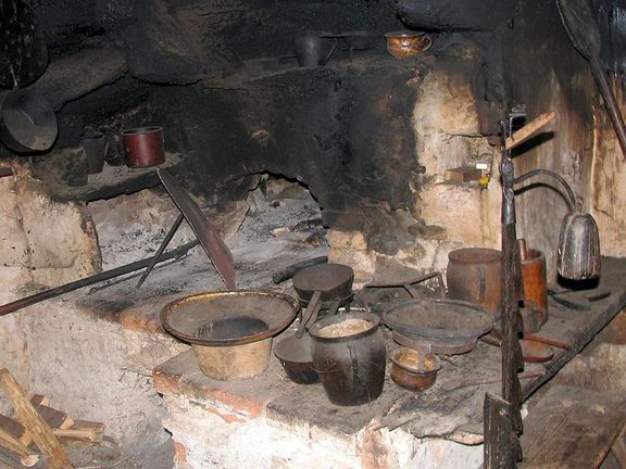 Kavčnik Homestead, the fireplace in the smokehouse [Dimnica] - an historic style of kitchen with no chimney. This was the first part of the building that was constructed, probably in the 17th century, with other rooms added later
