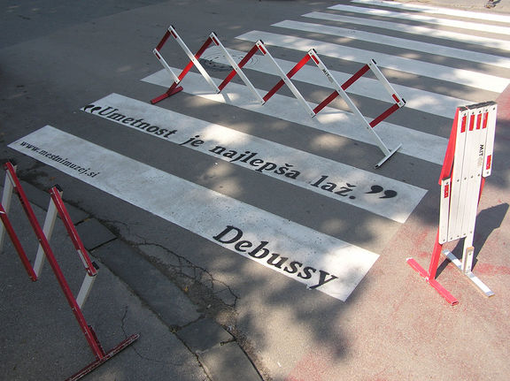Art project Street Poetry created for City Museum of Ljubljana by Poper Studio, 2011. The quote by Claude Debussy written on the crosswalk: "Art is the most beautiful deception of all".