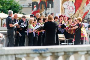 A mixed choir performing on one of Ljubljanica River's bridges at Praznik glasbe 2017