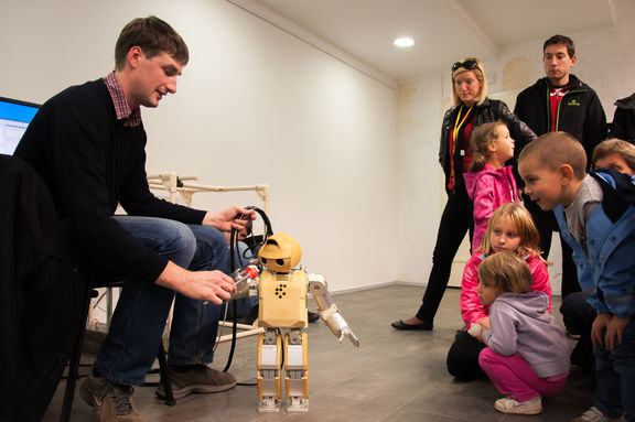 The younger visitors of the Speculum Artium Festival watching a project set up by the Jožef Stefan Institute, 2013