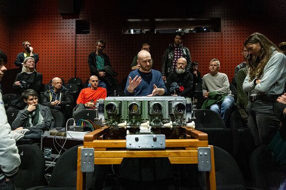 The presentation of Archeoscope, a special opto-mechanical projecting apparatus created for live film performances, invented and constructed by Czech filmmaker Jan Kulka, V-F-X Ljubljana 2023. Author: Asiana Jurca Avci
